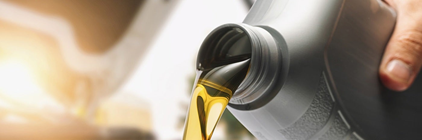Close up view of oil being poured from a bottle